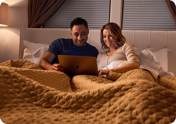 A couple browsing a laptop together