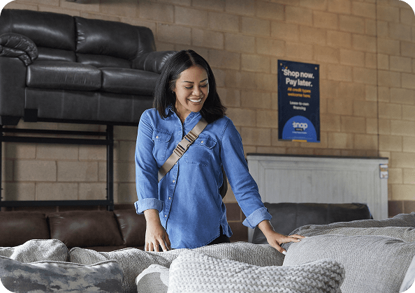 A woman shopping for a couch. 