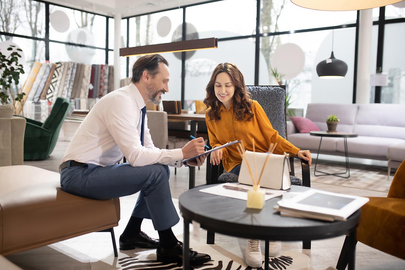 Two people discussing paperwork