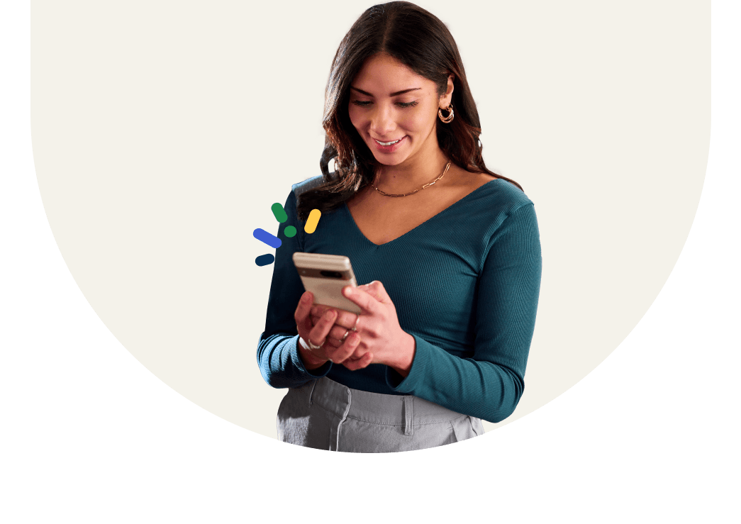 A woman looking at her phone and smiling.