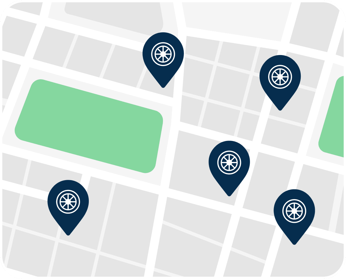 Map illustration with five location pins featuring a bicycle wheel icon, overlaid on streets and a green park area.