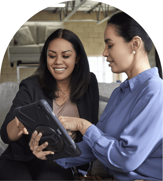 Two women reviewing a information on a tablet